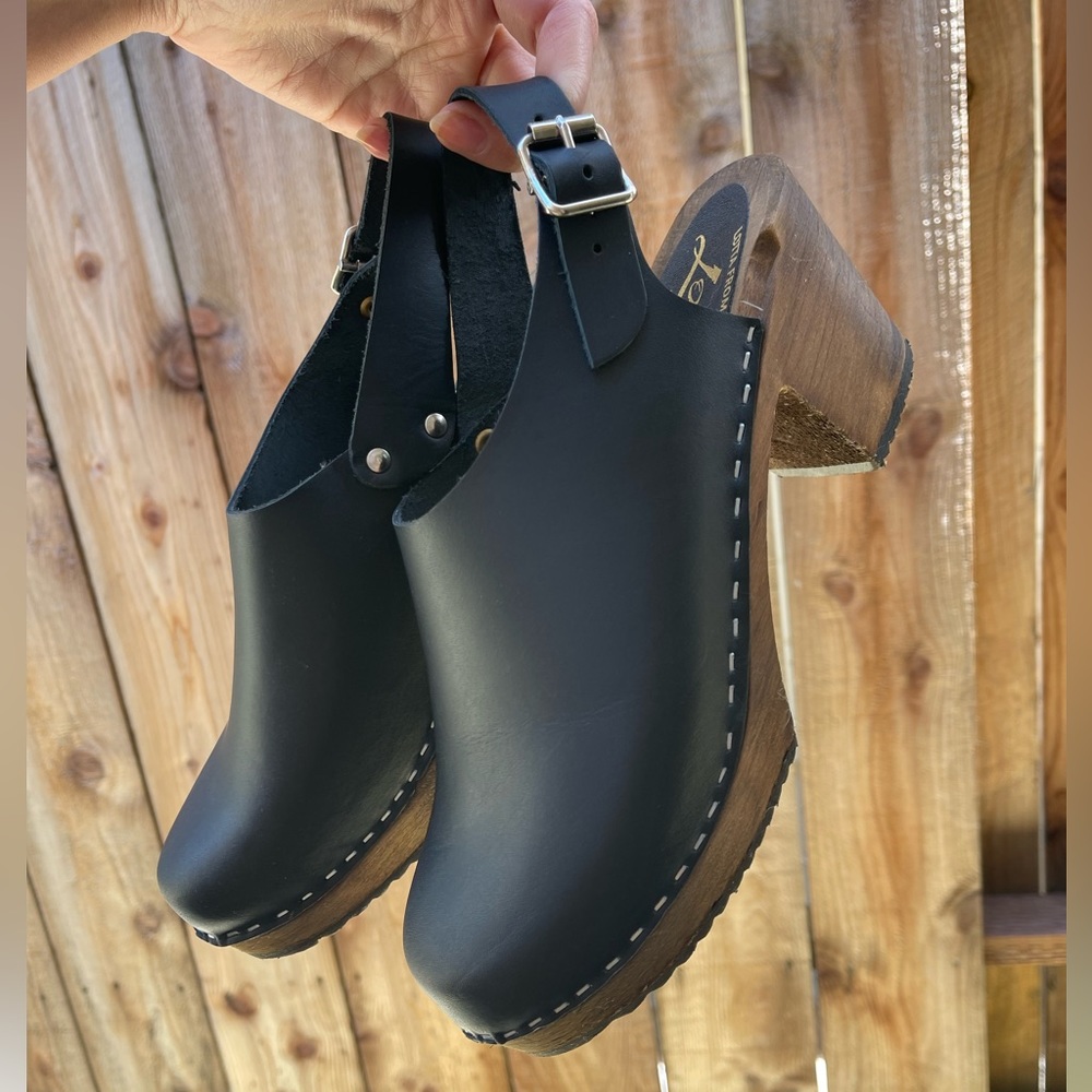 Black leather clogs
